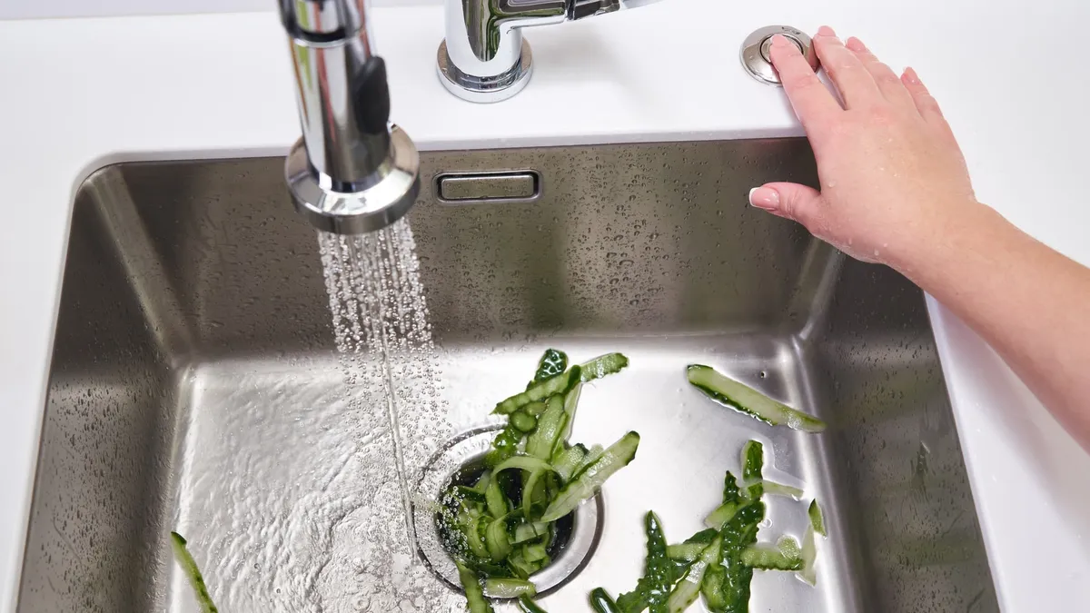 Activating garbage disposal to remove food waste