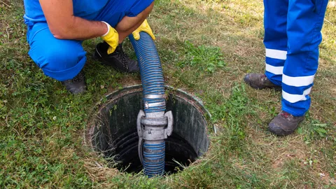 Men emptying a septic tank