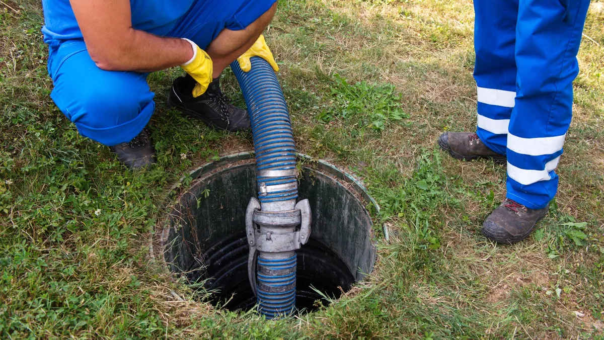 Men emptying a septic tank